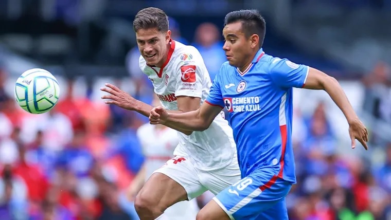 Cầu thủ Cruz Azul và Deportivo Toluca trong một pha tranh bóng quyết liệt trên sân cỏ.