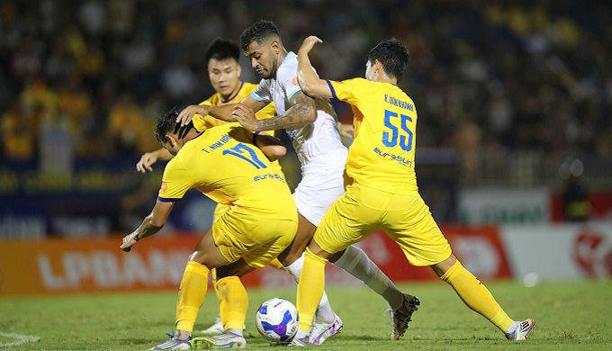 Cầu thủ Công an TPHCM và Nam Định tranh chấp bóng trên sân trong trận đấu V-League.
